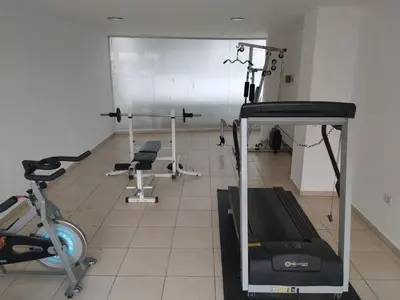 a gym with a treadmill and exercise bikes at Jardines del Boulevard 6 in Cordoba