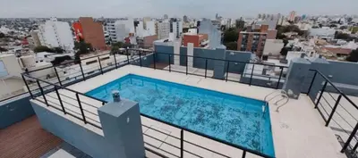 a swimming pool on the roof of a building at Departamento 1 dormitorio in Cordoba