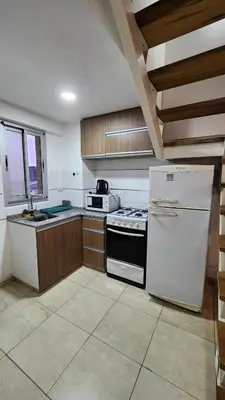 a kitchen with a stove and a white refrigerator at Deheza II- Gral Paz-BY Apartments in Cordoba