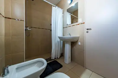 a bathroom with a sink and a toilet and a shower at Lavalleja II in Cordoba