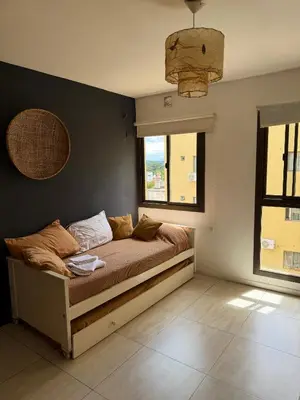 a bed in a room with a window at Departamento en el corazón de Villa Carlos Paz in Villa Carlos Paz