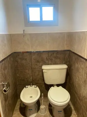 a bathroom with a toilet and a sink at Soligna-alquiler in Villa Santa Cruz del Lago