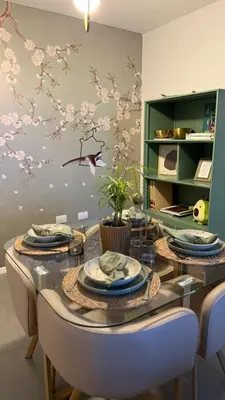 a dining room with a table with chairs and flowers on the wall at Dpto con vista a las sierras in Cordoba