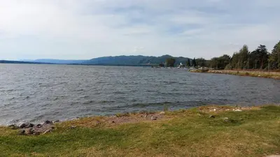 a large body of water with mountains in the background at Castillo Del Lago - Carlos Paz - D18 in Villa Carlos Paz