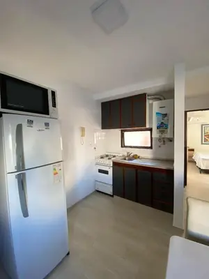 a kitchen with a white refrigerator with a microwave at Departamento cómodo en Cordoba Capital in Cordoba