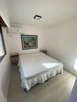 a bedroom with a bed in a white room at Departamento cómodo en Cordoba Capital in Cordoba