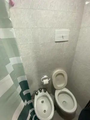 a small bathroom with a toilet and a bidet at Departamento cómodo en Cordoba Capital in Cordoba
