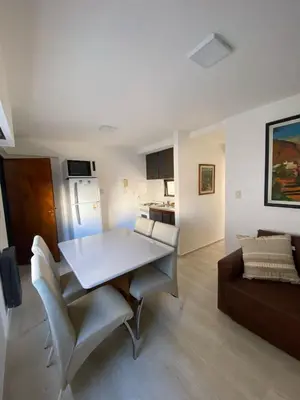 a living room with a white table and a couch at Departamento cómodo en Cordoba Capital in Cordoba