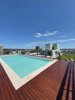 a swimming pool on the roof of a building at Departamento 1 dormitorio in Villa Carlos Paz