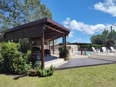 a wooden deck with a pavilion in a yard at Cabañas Finca del molino in Panaholma