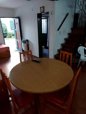 a wooden table in a room with a table and chairs at Castillo Del Lago - Carlos Paz - D19 in Villa Carlos Paz