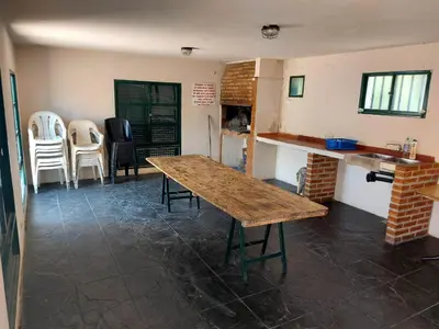 a room with a wooden table and chairs in it at Castillo Del Lago - Carlos Paz - D19 in Villa Carlos Paz