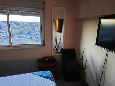 a living room with a tv and a window at Terra Zion in Cordoba