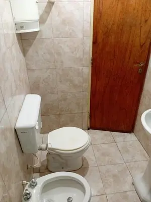 a bathroom with a toilet and a sink at Depto Alto Verde in Cordoba