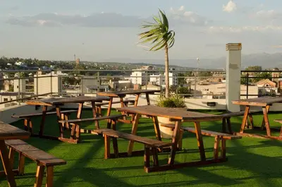 a group of picnic tables on the roof of a building at Departamento Céntrico Miralejos 3 in Villa Carlos Paz