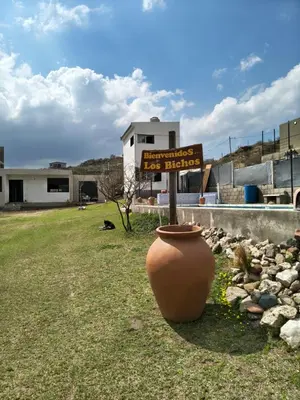 a sign in a yard with a large vase at Nono in Villa Carlos Paz