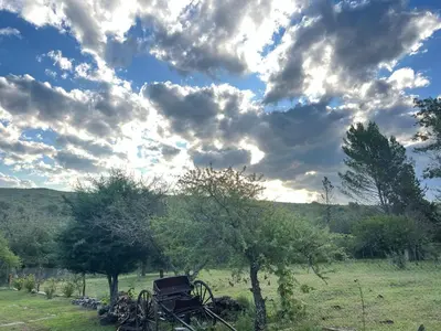 a group of bikes parked in a field under a cloudy sky at Punilla- Don Americo in Villa Carlos Paz