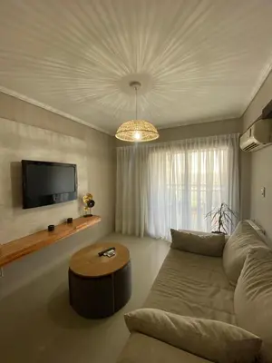 a living room with a couch and a flat screen tv at Departamento en córdoba, complejo Altos de Villasol , 3 dormitorios, 2 baños in Cordoba