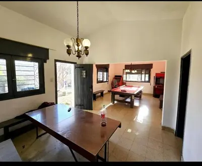 a living room with a table and a pool table at Cazona Villa Carmen in Villa Carlos Paz