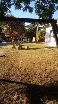 a view of a park with a tree and a bench at Cazona Villa Carmen2 in Villa Carlos Paz