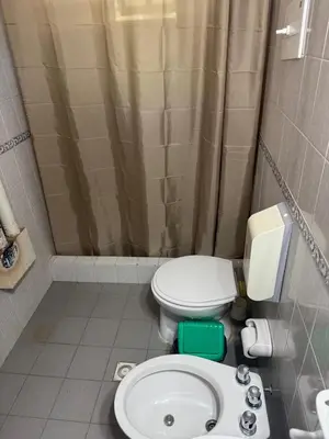 a bathroom with a toilet and a sink at Cabañas De La Colina in Villa General Belgrano
