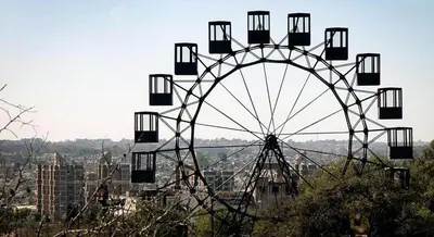 a large ferris wheel sitting on top of a city at Mandala Apart in Cordoba
