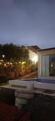 a house with a toilet in front of a window at Anima Lodge 2 in Villa Carlos Paz