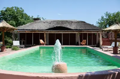 a fountain in the middle of a swimming pool at Cabañas Bendita Tierra - Calandrias in Los Molles