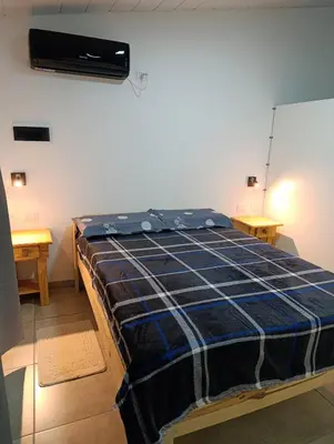 a bedroom with a bed in a room at Departamento Sinaí Apart in Santa Rosa de Calamuchita