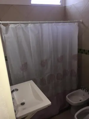 a bathroom with a sink and a shower curtain at Depto temporario Carlos paz in Villa Carlos Paz