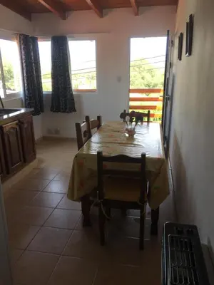 a kitchen and dining room with a table and chairs at Depto temporario Carlos paz in Villa Carlos Paz