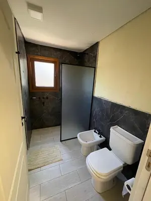 a bathroom with a toilet and a sink at La Madriguera de Potrerillo in Alta Gracia