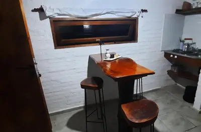 a bar in a room with two stools and a sink at CabañaPaz in Santa Rosa de Calamuchita