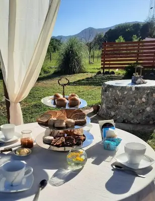 a table with plates of food on top of it at Cabaña Paz in Santa Rosa de Calamuchita