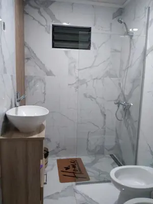 a bathroom with a toilet and a sink and a shower at Cabaña Villa Alpina,tanti córdoba in Tanti