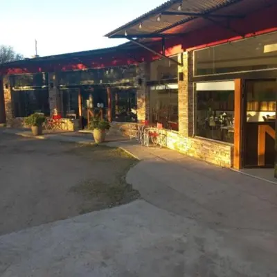 an empty parking lot in front of a building at Posada Miralejos in Trapiche