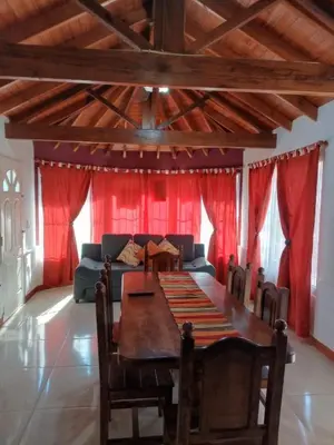 a dining room with a table and a couch at Divina providencia in Merlo