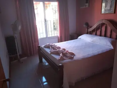 a bedroom with a bed and a window at Divina providencia in Merlo