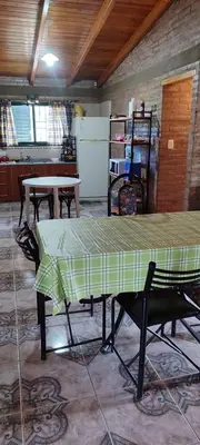 a room with a table with a green table cloth on it at Casa Villa Carlos paz in Villa Carlos Paz