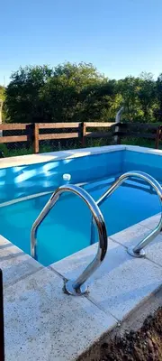 a swimming pool with a curved rail around it at Mateo y Stella 3 in Bialet Massé