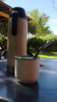 a cup sitting on top of a table with a spoon at Habitación Compartida Tipo Hostel para los más aventureros in Nono