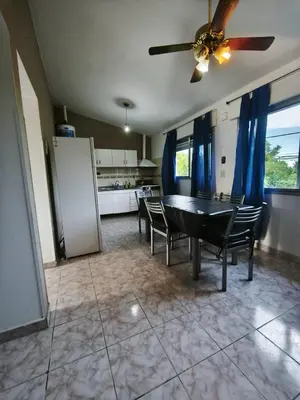 a dining room with a table and chairs and a kitchen at Dpto Villa Carlos Paz max 5 personas in Villa Carlos Paz