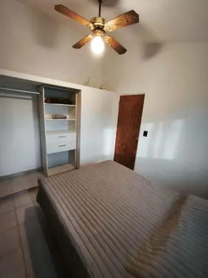 a bedroom with a bed and a ceiling fan at Dpto Villa Carlos Paz max 5 personas in Villa Carlos Paz