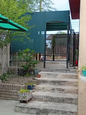 a set of stairs leading up to a bus stop at La Casita del Tano con Pileta in Villa Carlos Paz