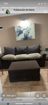 a black couch in a living room with at Habitación Individual con todas las comodidades in Cordoba