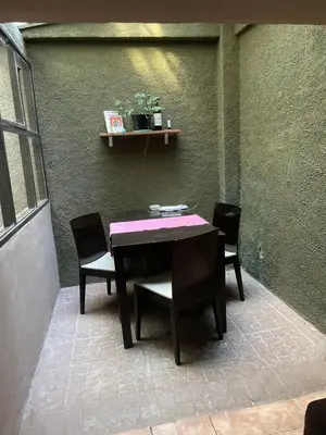 a table and chairs sitting on a patio at Habitación Individual con todas las comodidades in Cordoba