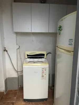 a small kitchen with a refrigerator and a microwave at Habitación Individual con todas las comodidades in Cordoba