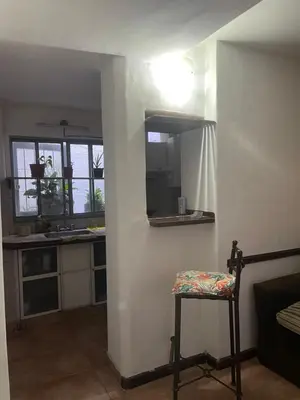a kitchen with a mirror and a chair in a room at Habitación Individual con todas las comodidades in Cordoba