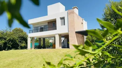 a house on a hill with green grass at Casa Potrero de Garay in La Estancia