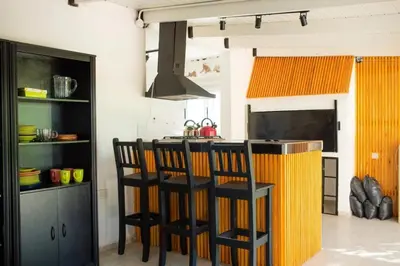 a kitchen with two bar stools and a counter at Casa Potrero de Garay in La Estancia